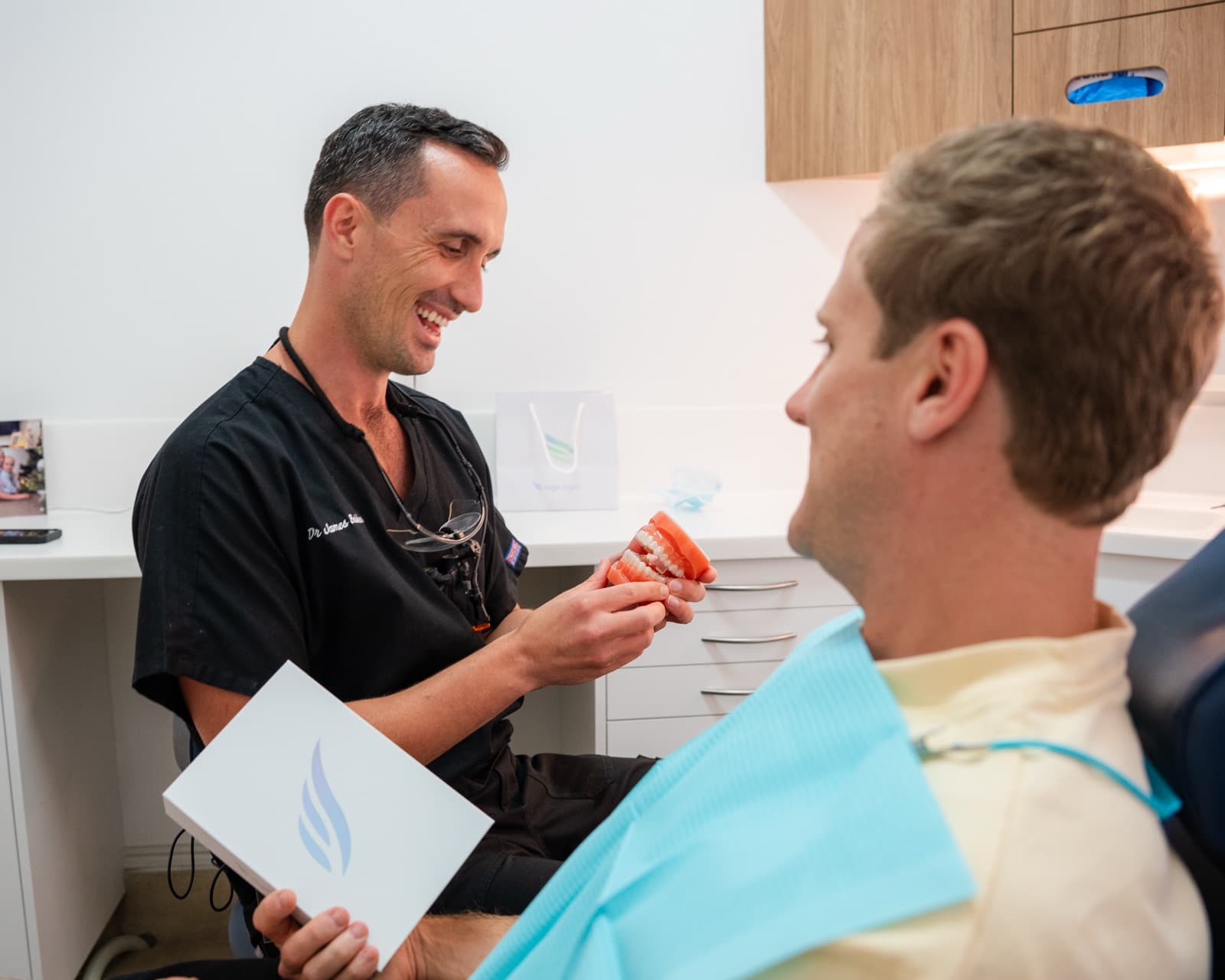 Dr James Bakker explaining treatment with a teeth model